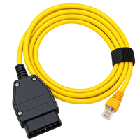 Câble ENET BMW jaune enroulé avec attache noire, prise OBD2 et connecteur Ethernet RJ45.